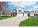 Beautiful home with a large driveway, well-kept lawn and a charming two-story facade at 7354 Ponderosa Pines Ln, Indianapolis, IN 46239