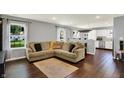 Bright living room with hardwood floors, comfortable seating, and open access to the kitchen at 902 Helm Dr, Avon, IN 46123