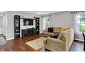 Spacious living room featuring hardwood floors, modern shelving, and a relaxing atmosphere at 902 Helm Dr, Avon, IN 46123