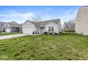 Attractive single-story home with a well-kept lawn and attached two-car garage at 9157 Tansel Crk Dr, Indianapolis, IN 46234