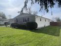 Charming single-story home with stone facade, attached garage, and well-maintained lawn at 9169 Hibben Ave, Indianapolis, IN 46229