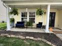 Inviting front porch with hanging plants, comfortable seating, and classic column supports at 9873 Blue Ridge Way, Indianapolis, IN 46234