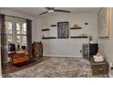 Charming living room featuring luxury vinyl plank flooring, shelving, and a decorative ceiling fan at 9873 Blue Ridge Way, Indianapolis, IN 46234