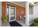 Inviting front porch with brick accents, white columns, and a cozy seating area at 10471 Meadow Lake Dr, Fishers, IN 46038