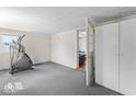 Bedroom with gray carpet, workout equipment and doorway to the living area at 1126 N Anderson St, Elwood, IN 46036