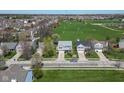 Aerial view of a neighborhood with well-maintained lawns and a large grassy field nearby at 12258 Weathered Edge Dr, Fishers, IN 46037