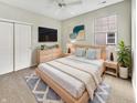 Cozy bedroom with a comfortable bed, neutral tones, and a mounted TV at 12521 Hawks Landing Dr, Fishers, IN 46037