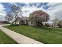 A brick home with a three car garage and mature trees at 1304 Park Meadow Dr, Beech Grove, IN 46107