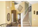 The foyer features high ceilings, decorative wall art, and a staircase leading to the upper level at 1416 Gleneagle Dr, Indianapolis, IN 46239