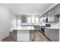 New kitchen with an island, stainless steel appliances, gray cabinetry, and white subway tile backsplash at 14538 Hanford Ln, Carmel, IN 46074
