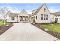 Charming single-Gathering home boasts a brick exterior, manicured lawn, and an attached garage at 1501 Chanson Ln, Westfield, IN 46074