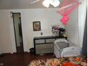 Cozy bedroom featuring dark wood floors and good natural light at 1722 N Parker Ave, Indianapolis, IN 46218