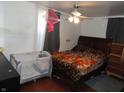 Cozy bedroom featuring dark wood floors and good natural light at 1722 N Parker Ave, Indianapolis, IN 46218