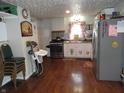 Spacious kitchen with stainless steel appliances, white cabinetry, and hard wood floors at 1722 N Parker Ave, Indianapolis, IN 46218
