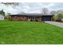Charming red brick single-story home with a well-manicured green lawn at 1741 Terrace Ct, Franklin, IN 46131