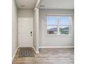 Bright entryway featuring wood-look floors, a neutral color palette, and a window for natural light at 1862 Downey Ln, Greenfield, IN 46140