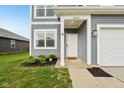 Inviting entryway with white door, stylish house number, and green landscaping, enhancing curb appeal at 1862 Downey Ln, Greenfield, IN 46140