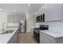 A well-lit, modern kitchen featuring stainless steel appliances and light gray cabinets at 18745 Moray St, Westfield, IN 46074