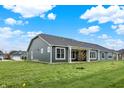Backyard view of home featuring many windows and a columned patio, with sprawling green space at 19113 River Jordan Pass, Westfield, IN 46074