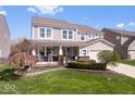 Charming two-story home boasts a manicured lawn, covered porch and attached two-car garage at 19546 Forsythe Dr, Noblesville, IN 46060