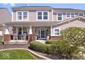 Charming two-story home featuring a covered porch with white rocking chairs, adding to its curb appeal at 19546 Forsythe Dr, Noblesville, IN 46060