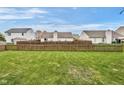 Large, green backyard enclosed by a wooden fence, providing ample space and privacy at 24 W Pine Ridge Dr, Westfield, IN 46074