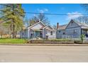 Light gray home with a blue front door and matching gray home nearby at 2531 E Brookside Ave, Indianapolis, IN 46218