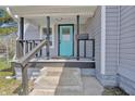 Inviting front porch with gray siding and a blue front door at 2531 E Brookside Ave, Indianapolis, IN 46218