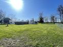Large backyard with an expansive lawn, partially enclosed by a wooden fence at 2575 S Indianapolis Rd, Lebanon, IN 46052