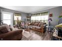 Cozy living room with hardwood floors, two sofas, an arm chair and decorative curtains at 3021 Midvale Dr, Indianapolis, IN 46222