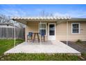 Inviting patio featuring a retractable awning, table, and chairs for outdoor enjoyment at 3021 Midvale Dr, Indianapolis, IN 46222