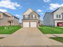 Charming two-story home with a two-car garage and a well-manicured front lawn at 3053 Creekridge Ct, Columbus, IN 47201