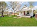 Quaint home featuring a welcoming front porch and a spacious, green front yard at 3414 Arbor Ave, Indianapolis, IN 46217