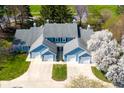Aerial view of townhomes showcasing well-manicured lawns, mature trees, and convenient garage access at 3624 N Lakeside Dr, Muncie, IN 47304