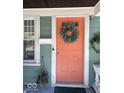 Close-up of the front door showcasing its unique color and wreath at 37 N Arlington Ave, Indianapolis, IN 46219