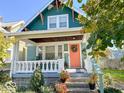 Inviting curb appeal with a cozy front porch and colorful garden at 37 N Arlington Ave, Indianapolis, IN 46219