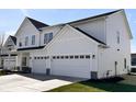 Modern two-story home featuring a two-car garage, white siding, and black trim at 3767 Thomas Jefferson Ct, Westfield, IN 46074