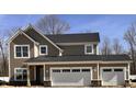 Craftsman-style home with a two-car garage, stone accents, shake siding, and horizontal siding at 3818 Thomas Jefferson Ct, Westfield, IN 46074