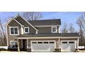 Two story craftsman style house with a two car garage, stone accents, and two toned horizontal and shake siding at 3818 Thomas Jefferson Ct, Westfield, IN 46074