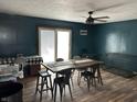 Dining room featuring a dark accent wall and a rustic wood table with metal chairs at 389 W Poston Rd, Martinsville, IN 46151