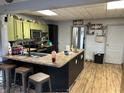 An open kitchen features lime green upper cabinets and a large island with seating at 389 W Poston Rd, Martinsville, IN 46151