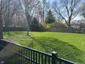 Large, well-maintained backyard with a wood fence, offering ample space for outdoor activities and privacy at 3911 E 75Th St, Indianapolis, IN 46240
