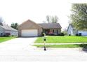 Lovely single-story brick home with an attached two-car garage and mature landscaping in the front yard at 45 Golden Tree Ln, Indianapolis, IN 46227