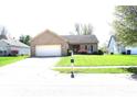 Well maintained single-story brick home with a manicured lawn and an attached two-car garage at 45 Golden Tree Ln, Indianapolis, IN 46227
