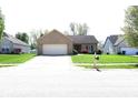 Beautiful single-story brick home with a well-maintained lawn and an attached two-car garage at 45 Golden Tree Ln, Indianapolis, IN 46227