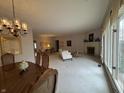Large living room featuring a dining space, fireplace, and big windows at 4586 Aldersgate Dr, Carmel, IN 46033