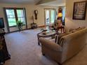 Comfortable living room with plush seating, large windows, and a view to the patio at 5122 Montpelier Ct, Columbus, IN 47203