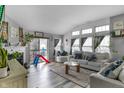 Bright living room boasts a fireplace, vaulted ceiling, and natural light, offering a comfortable living space at 5157 Climbing Rose Pl, Indianapolis, IN 46254