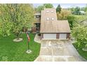 Aerial view of a two-story home, three-car garage, large yard, and mature trees at 5298 Royal Troon Way, Avon, IN 46123