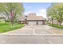 Attractive two-story home with three-car garage, flag pole, lush lawn, and inviting curb appeal at 5298 Royal Troon Way, Avon, IN 46123